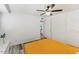 Comfortable bedroom featuring light walls, wood-look flooring, and a ceiling fan at 8209 E Heatherbrae Ave, Scottsdale, AZ 85251