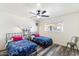 Bright bedroom featuring twin beds, a ceiling fan, and natural light from a window at 8209 E Heatherbrae Ave, Scottsdale, AZ 85251
