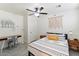 Well-lit bedroom featuring a ceiling fan, desk and closet at 8209 E Heatherbrae Ave, Scottsdale, AZ 85251