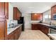 Updated kitchen features granite countertops, stainless steel appliances, and beautiful wood cabinetry at 8209 E Heatherbrae Ave, Scottsdale, AZ 85251