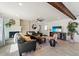 Stylish living area with a brick fireplace, sleek furniture, and contemporary accents at 8209 E Heatherbrae Ave, Scottsdale, AZ 85251
