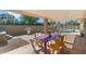 Covered patio area with a table, chairs, grill, and a view of the pool at 8209 E Heatherbrae Ave, Scottsdale, AZ 85251
