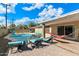 Inviting backyard pool area with lounge chairs, a hammock, and well-maintained landscaping at 8209 E Heatherbrae Ave, Scottsdale, AZ 85251