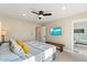 Well-appointed bedroom includes an ensuite bathroom, TV, ceiling fan, and neutral decor at 8213 E Fairmount Ave, Scottsdale, AZ 85251