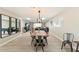 Bright dining room featuring modern lighting, wood-look flooring, and views into the living area at 8213 E Fairmount Ave, Scottsdale, AZ 85251