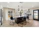 Modern kitchen boasts a large island with pendant lighting and a seamless connection to the outdoor patio at 8213 E Fairmount Ave, Scottsdale, AZ 85251