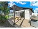 Charming outdoor patio with a dining table, chairs and well-manicured backyard and pool in the background at 8213 E Fairmount Ave, Scottsdale, AZ 85251