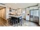 Well-lit kitchen boasting stainless steel appliances, white cabinetry, and a center island with seating at 8227 N 15Th Pl, Phoenix, AZ 85020