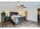 Spacious main bedroom with hardwood floors, ceiling fan, and an ensuite bathroom at 8227 N 15Th Pl, Phoenix, AZ 85020