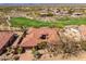 Expansive aerial view of the home with red tile roof, golf course, lush landscaping, and surrounding desert at 9630 E Preserve Way, Scottsdale, AZ 85262