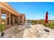Outdoor patio boasts tiled floors, lounge seating, a refreshing pool, and desert views at 9630 E Preserve Way, Scottsdale, AZ 85262