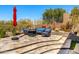 Outdoor seating area with stone patio, perimeter fence, and decorative landscaping at 9630 E Preserve Way, Scottsdale, AZ 85262
