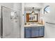 Modern bathroom features a glass shower and blue vanity with a white sink at 9630 E Preserve Way, Scottsdale, AZ 85262