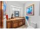 Charming bathroom with tile backsplash, wooden cabinets, and decorative artwork at 9630 E Preserve Way, Scottsdale, AZ 85262