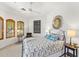 Bright bedroom with a patterned bedspread, sunburst mirror and shuttered windows at 9630 E Preserve Way, Scottsdale, AZ 85262