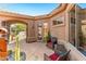 Outdoor patio area with desert landscaping, seating, and covered access to the interior at 9630 E Preserve Way, Scottsdale, AZ 85262