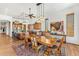 Open-concept dining and kitchen area with hardwood floors, island seating, and modern appliances at 9630 E Preserve Way, Scottsdale, AZ 85262