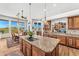 Spacious kitchen featuring a large center island, granite countertops, and an adjacent dining area with scenic views at 9630 E Preserve Way, Scottsdale, AZ 85262