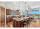 This kitchen has a large island with seating and modern appliances next to the dining area with mountain views at 9630 E Preserve Way, Scottsdale, AZ 85262