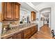 The kitchen features granite countertops and custom cabinets that lead into a hallway with decorative wall art at 9630 E Preserve Way, Scottsdale, AZ 85262