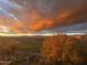 Scenic view of a golf course and distant mountains under a beautiful sunset sky with colorful, dramatic clouds at 9630 E Preserve Way, Scottsdale, AZ 85262