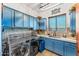 Laundry room featuring blue cabinets, modern washer and dryer, and countertops at 9630 E Preserve Way, Scottsdale, AZ 85262