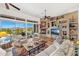 Inviting living room featuring a stone fireplace, built-in shelves, plush seating, and scenic outdoor views at 9630 E Preserve Way, Scottsdale, AZ 85262
