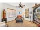 Cozy reading room featuring natural light, comfortable seating, and a built-in bookshelf at 9630 E Preserve Way, Scottsdale, AZ 85262