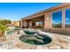 Private pool and spa area featuring travertine tile, rock accents, and lush landscaping, perfect for a luxurious retreat at 9630 E Preserve Way, Scottsdale, AZ 85262