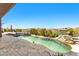 Private pool features a cascading waterfall, spa, and travertine tile deck, offering relaxation and scenic views at 9630 E Preserve Way, Scottsdale, AZ 85262
