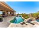 Sparkling pool with rock features, travertine tile, and desert views; perfect for outdoor relaxation and enjoyment at 9630 E Preserve Way, Scottsdale, AZ 85262