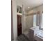 Walk-in shower featuring stone flooring, a glass enclosure, a built-in shower head, and a handheld sprayer at 9630 E Preserve Way, Scottsdale, AZ 85262