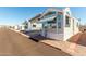 Adorable manufactured home with covered parking, large windows, and low-maintenance desert landscaping at 9736 E Main St # 43, Mesa, AZ 85207