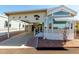 Charming manufactured home features covered parking, a porch, and attractive desert landscaping at 9736 E Main St # 43, Mesa, AZ 85207