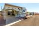 This cute manufactured home has covered parking, large front windows, and charming desert landscaping at 9736 E Main St # 43, Mesa, AZ 85207