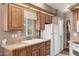 Practical kitchen with a double sink, wooden cabinets and white appliances for everyday convenience at 9736 E Main St # 43, Mesa, AZ 85207