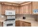 Kitchen featuring a white oven, cooktop, microwave and ample counter space for meal preparation at 9736 E Main St # 43, Mesa, AZ 85207
