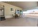 Patio area with dining set near the entry of a charming manufactured home at 9736 E Main St # 43, Mesa, AZ 85207
