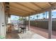 Covered patio with seating, ideal for outdoor dining and entertaining overlooking the backyard at 9853 E Birchwood Ave, Mesa, AZ 85208