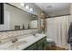 This updated bathroom features double sinks, modern fixtures, and patterned wallpaper at 9853 E Birchwood Ave, Mesa, AZ 85208