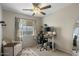 Office/Bedroom with neutral colors, a ceiling fan, and a well-lit workspace at 9853 E Birchwood Ave, Mesa, AZ 85208