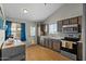 Modern kitchen featuring stainless steel appliances, stylish backsplash, and lots of natural light at 9853 E Birchwood Ave, Mesa, AZ 85208