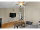 Spacious living room with vaulted ceilings, wood floors, and a large TV at 9853 E Birchwood Ave, Mesa, AZ 85208