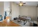 Bright living room featuring wood floors, ceiling fan, neutral colors and a comfortable couch at 9853 E Birchwood Ave, Mesa, AZ 85208