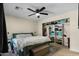 Cozy primary bedroom featuring a ceiling fan and a large closet with built-in shelving at 9853 E Birchwood Ave, Mesa, AZ 85208