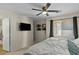 Relaxing primary bedroom featuring a ceiling fan, a window, and modern lighting at 9853 E Birchwood Ave, Mesa, AZ 85208