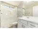 This bathroom features a walk-in shower with glass door, light wood floors and a white vanity at 1021 W Vineyard Plains Dr, San Tan Valley, AZ 85143