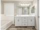 Bright bathroom featuring double sinks, white cabinets, and a large mirror for convenience and functionality at 1021 W Vineyard Plains Dr, San Tan Valley, AZ 85143