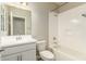 The bathroom features a vanity, mirror, toilet, and shower-tub combination with white tiling at 1021 W Vineyard Plains Dr, San Tan Valley, AZ 85143