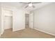 This bedroom has neutral walls, neutral carpet, and two doors at 1021 W Vineyard Plains Dr, San Tan Valley, AZ 85143